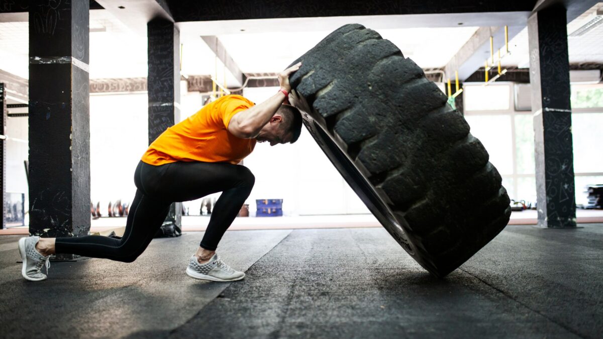 Athlete working out pushing a big tire