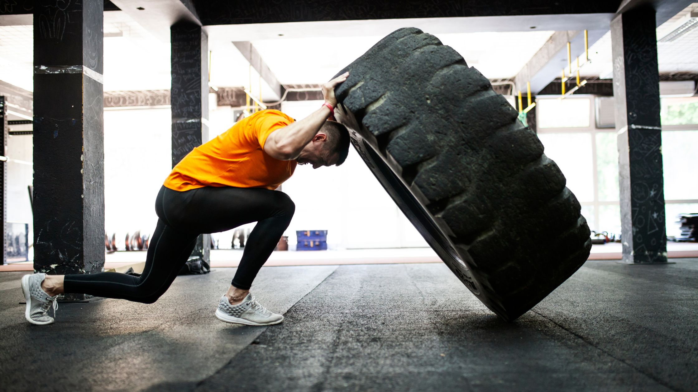 Athlete working out pushing a big tire